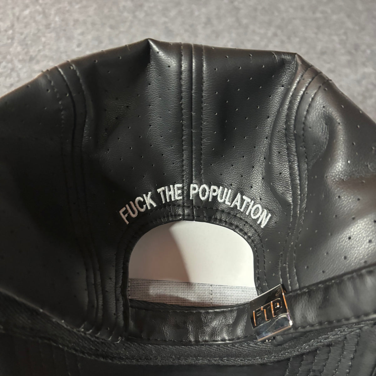 Fuck The Population perforated leather hat