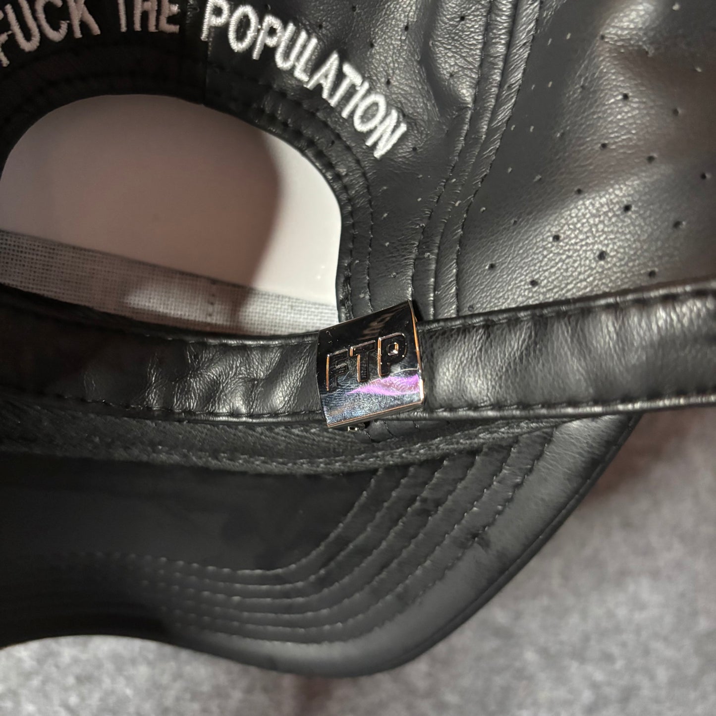 Fuck The Population perforated leather hat